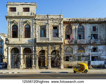 Stock Photograph - The weathered facade of a residential building along a street; Havana, Cuba. Fotosearch