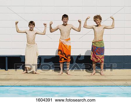 Stock Image - Three boys flex muscles. Fotosearch