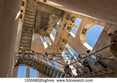 Stock Photograph - Tourists ascending and descending the steps to the top of St Domnius Bell Tower on the Peristyle of Diocletian's Palace; Split, Croatia. Fotosearch