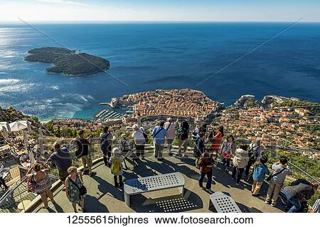 Stock Photograph - Tourists enjoying the view of the Old City of Dubrovnik and Lokrum Island, Dubrovnik-Neretva County, Croati. Fotosearch