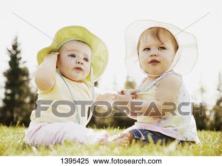 Stock Photography - Two babies sit together. Fotosearch