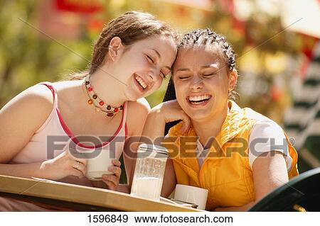 Stock Photo - Two girls having coffee together. Fotosearch