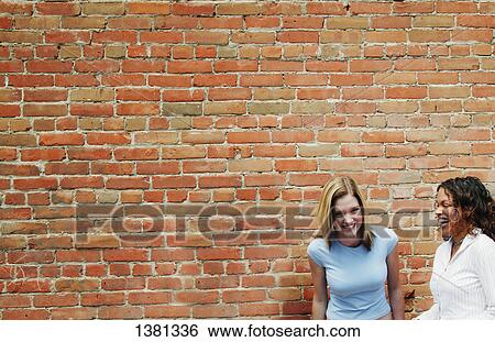 Two girls laugh together View Large Photo Image Stock Photograph - Two girls laugh together. Fotosearch