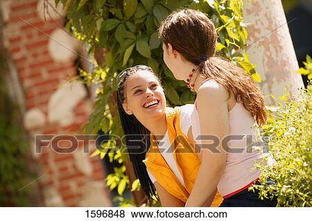 Two girls share a joke View Large Photo Image Stock Photo - Two girls share a joke. Fotosearch