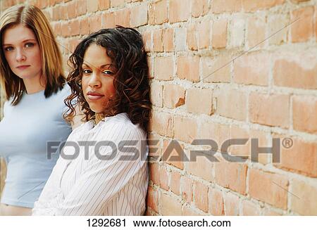 Stock Image - Two women waiting around. Fotosearch