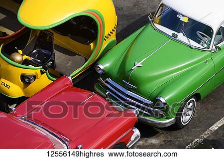 Stock Photograph - Vintage cars parked; Havana, Cuba. Fotosearch