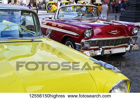 Stock Photograph - Vintage cars parked; Havana, Cuba. Fotosearch