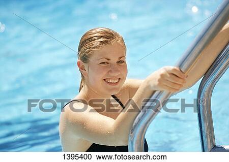 Stock Image - Woman getting out of the pool. Fotosearch