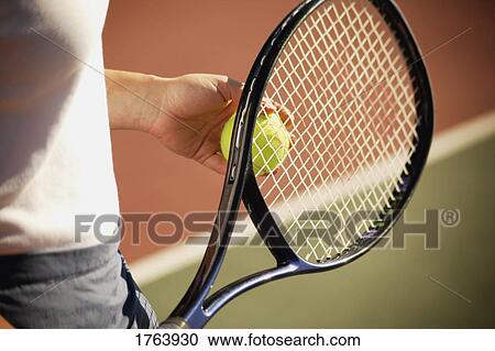 Woman holding a racket and ball View Large Photo Image Stock Image - Woman holding a racket and ball. Fotosearch