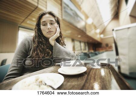 Picture - Woman looks at food. Fotosearch