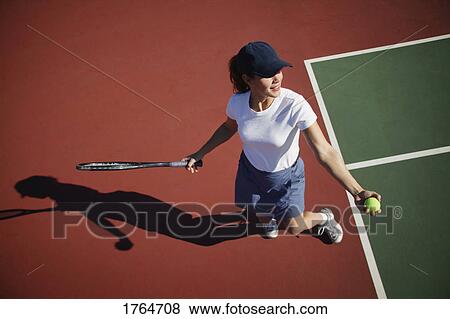 Stock Photo - Woman playing tennis. Fotosearch