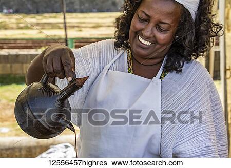 Woman serving coffee in jebena buna, a traditional Ethiopian coffee ceremony; Addis Ababa, Addis Ababa, Ethiopia View Large Photo Image Stock Photograph - Woman serving coffee in jebena buna, a traditional Ethiopian coffee ceremony; Addis Ababa, Addis Ababa, Ethiopia. Fotosearch