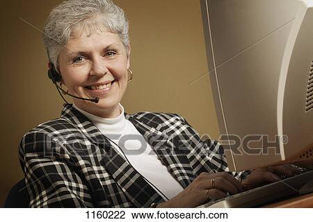 Stock Image - Woman with headset. Fotosearch