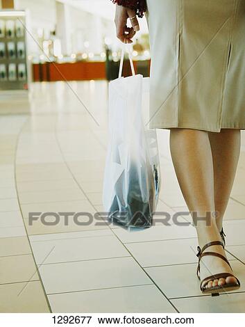 Stock Photo - Woman with shopping bag. Fotosearch