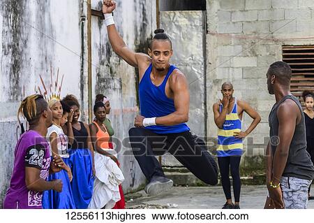 Stock Photograph - Young Cuban men dancing in an old concrete building with graffiti on the walls; Havana, Cuba. Fotosearch