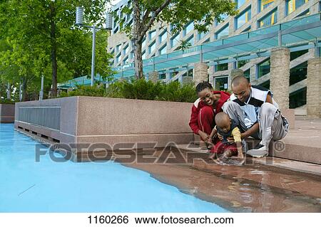 Young family by water View Large Photo Image Stock Photograph - Young family by water. Fotosearch