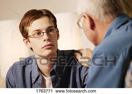 Stock Image - Young man getting counseling. Fotosearch