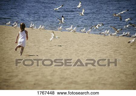 A child runs on the beach View Large Photo Image Stock Photo - A child runs on the beach. Fotosearch