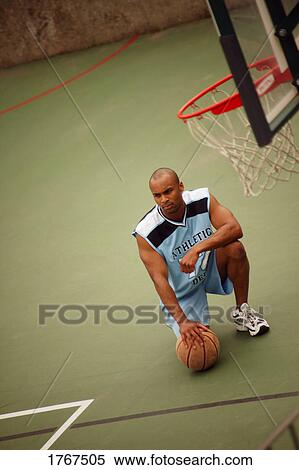 Stock Photography - A man in a basketball court. Fotosearch