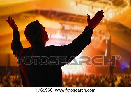 Stock Photograph - A man with arms raised. Fotosearch