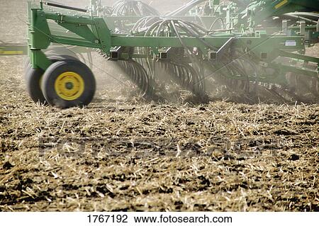 A tractor in a field View Large Photo Image Stock Image - A tractor in a field. Fotosearch