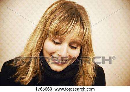 A woman looks down View Large Photo Image Stock Photo - A woman looks down. Fotosearch