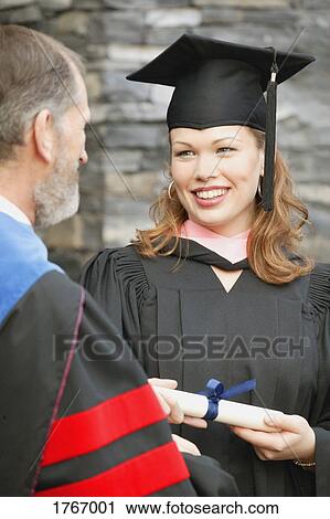 Stock Image - A woman receives her diploma. Fotosearch