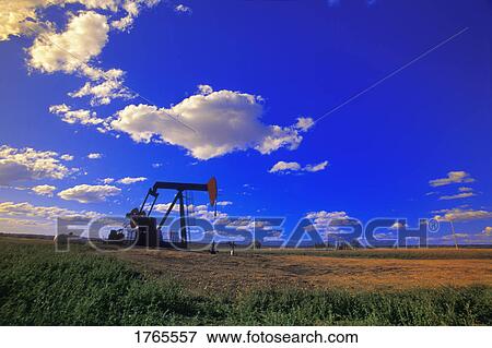 Stock Photo - An oil derrick in a field. Fotosearch