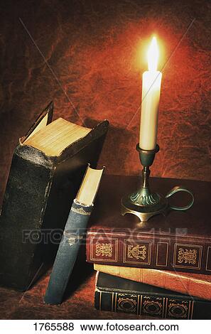 Stock Photo - Books and candle. Fotosearch