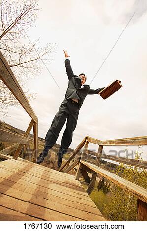 Stock Image - Businessman jumps. Fotosearch
