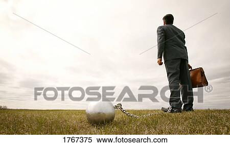 Stock Photography - Businessman with ball and chain. Fotosearch