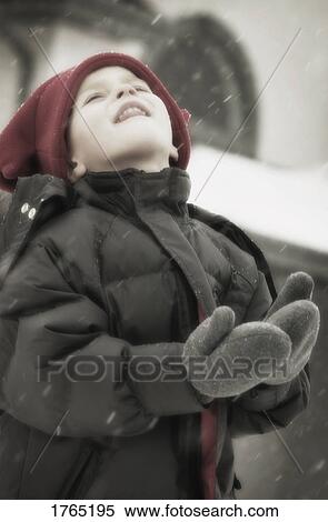 Child enjoys catching snowflakes View Large Photo Image Stock Photography - Child enjoys catching snowflakes. Fotosearch