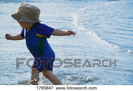 Child plays in water View Large Photo Image Stock Photo - Child plays in water. Fotosearch