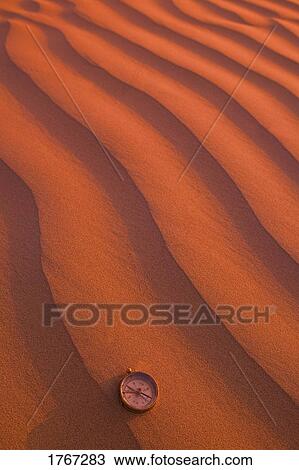 Compass pointing direction in the waves of desert sand View Large Photo Image Stock Image - Compass pointing direction in the waves of desert sand. Fotosearch
