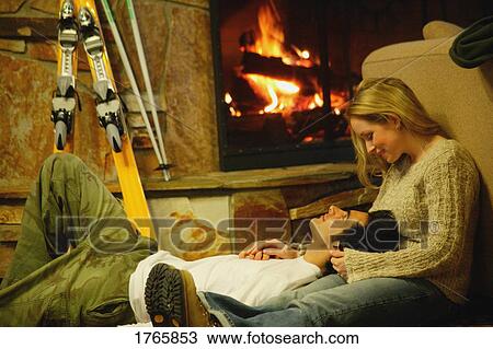 Couple relax by fireplace View Large Photo Image Stock Image - Couple relax by fireplace. Fotosearch