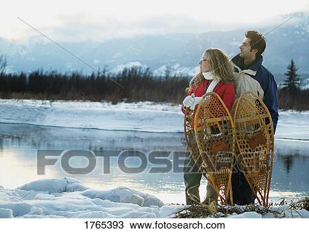 Stock Image - Couple with snowshoes. Fotosearch