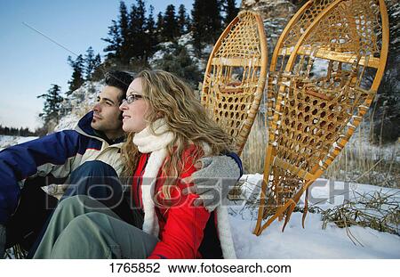 Couple with snowshoes View Large Photo Image Stock Image - Couple with snowshoes. Fotosearch