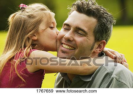 Stock Photo - Daughter kisses father. Fotosearch