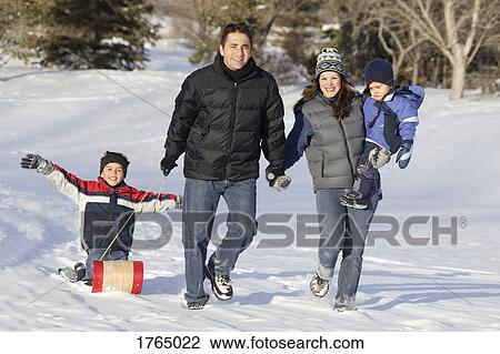 Family goes tobogganing View Large Photo Image Stock Image - Family goes tobogganing. Fotosearch