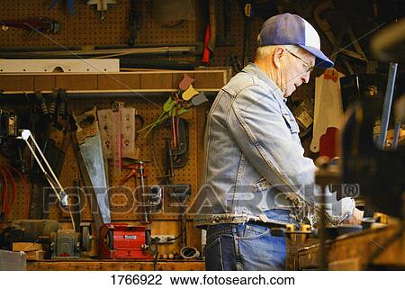 Stock Image - Man in workshop. Fotosearch