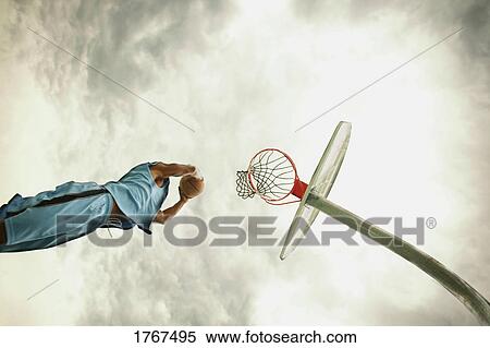 Stock Photography - Man playing basketball. Fotosearch