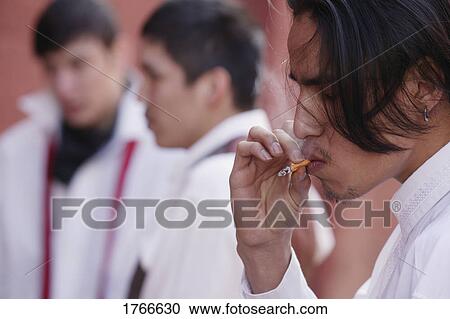 Stock Image - Man smokes a cigarette. Fotosearch