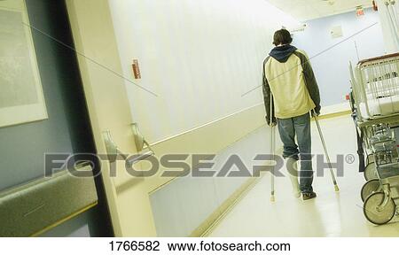 Stock Image - Man with crutches. Fotosearch