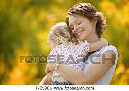 Stock Photography - Mother hugs daughter. Fotosearch