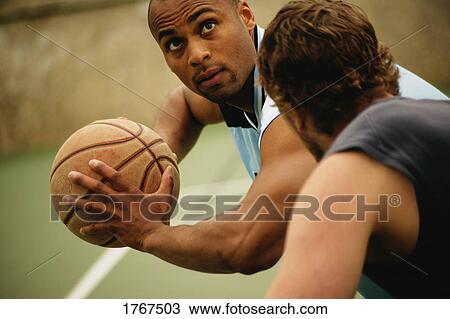 Stock Image - Playing basketball. Fotosearch