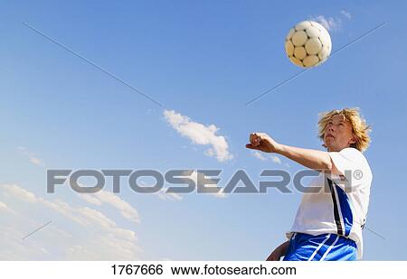Stock Photograph - Playing soccer. Fotosearch