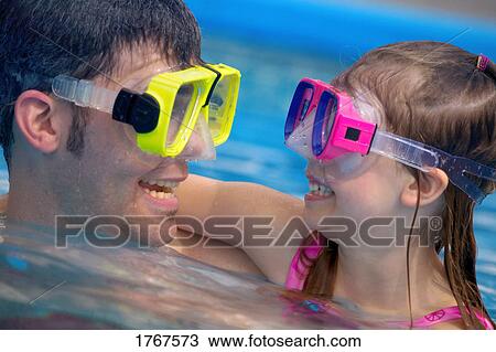 Portrait of father and daughter swimming View Large Photo Image Stock Image - Portrait of father and daughter swimming. Fotosearch