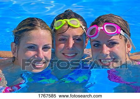 Portrait of three young women in swimming pool View Large Photo Image Stock Photography - Portrait of three young women in swimming pool. Fotosearch