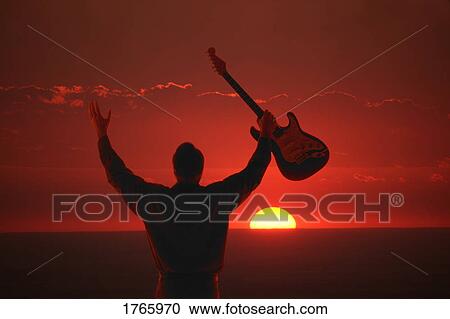 Raising a guitar View Large Photo Image Stock Image - Raising a guitar. Fotosearch