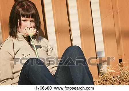 Stock Image - Smelling the flowers. Fotosearch